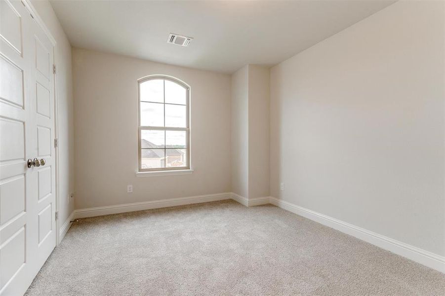 Spare room with light colored carpet