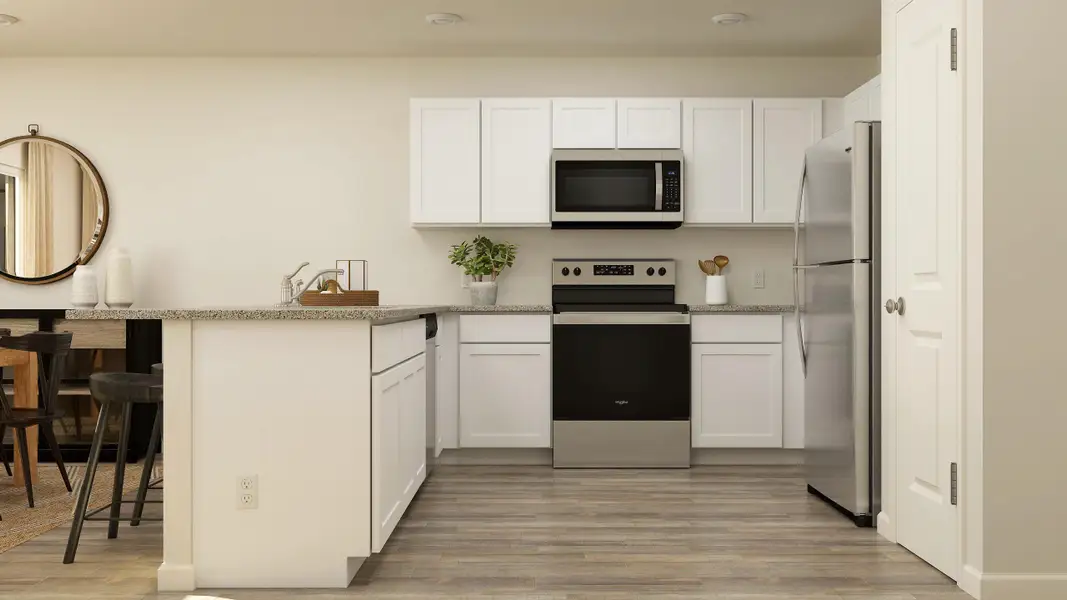 A kitchen with white cabinets.