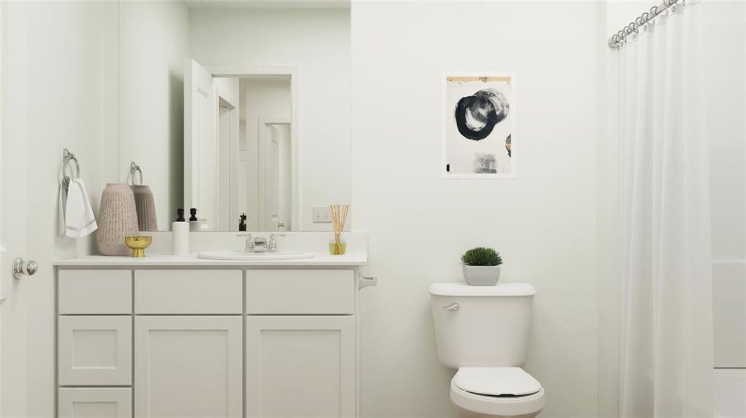 Bathroom featuring vanity and toilet