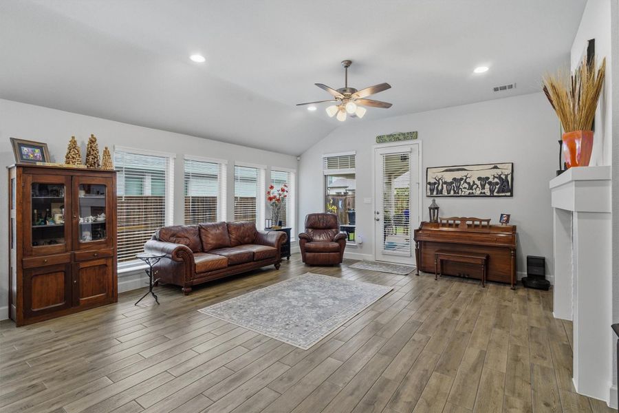 Spacious living room area with wall of windows letting in natural light Spacious living room area with wall of windows letting in natural light