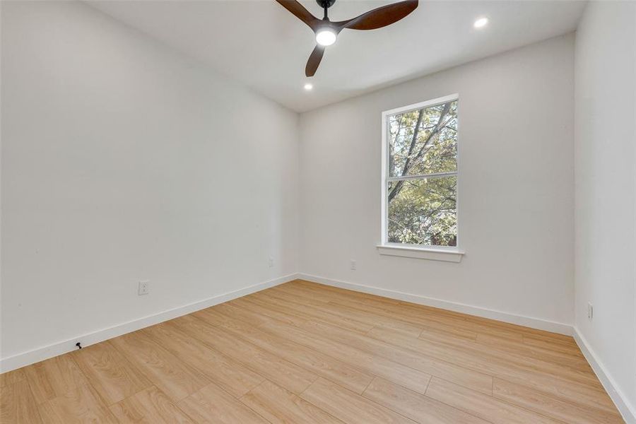 Unfurnished room featuring ceiling fan and light hardwood / wood-style flooring