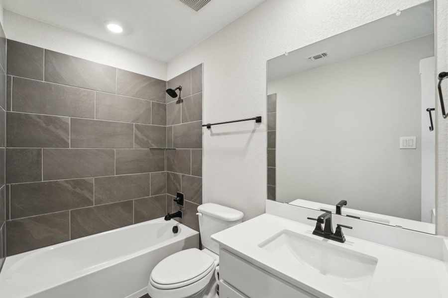 upstiars Full bathroom with toilet, visible vents, vanity, and shower combination upstiars Full bathroom with toilet, visible vents, vanity, and shower combination