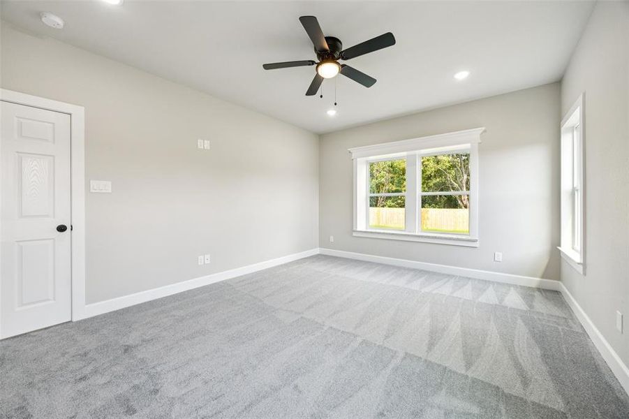 Spare room featuring carpet flooring, a ceiling fan, and recessed lighting Spare room featuring carpet flooring, a ceiling fan, and recessed lighting
