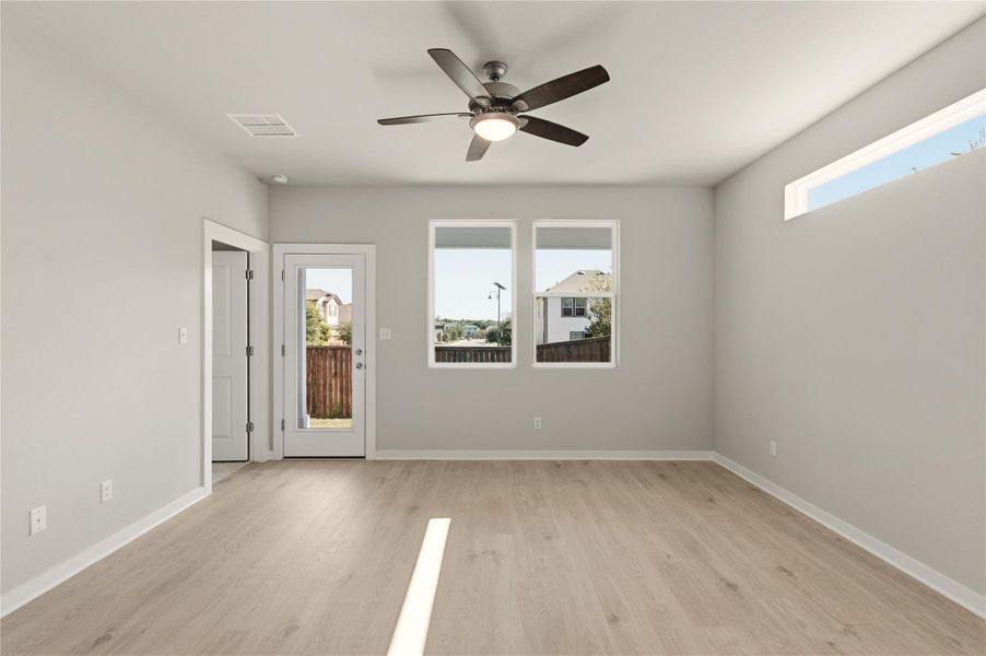 Empty room with light wood-style flooring and ceiling fan