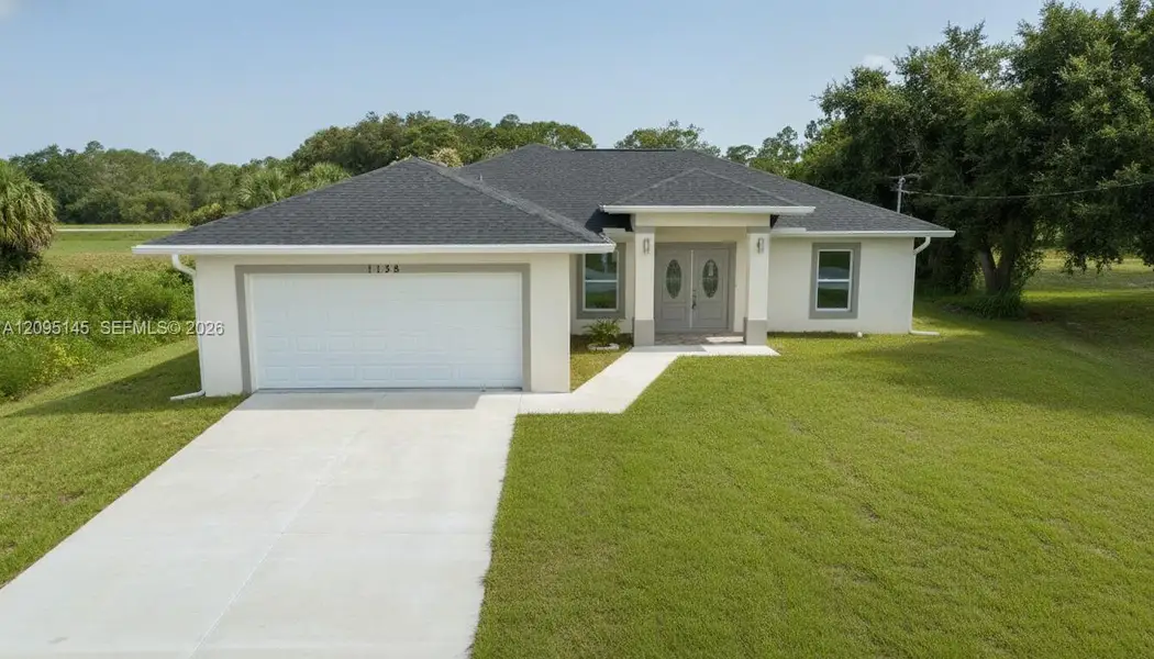 Front exterior of a new home in , Labelle, FL, highlighting curb appeal (Image 2). Front exterior of a new home in , Labelle, FL, highlighting curb appeal (Image 2).