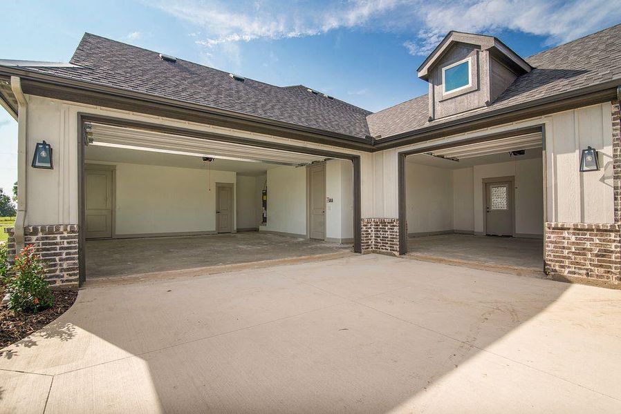 The two garages have a walk thru path. The double and single garages are oversized.