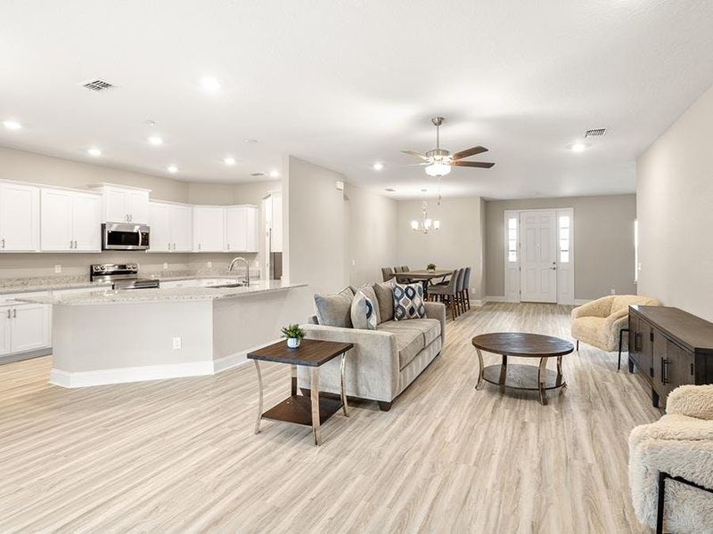 Inside, you`ll find a spacious, open living area with luxury vinyl plank flooring.