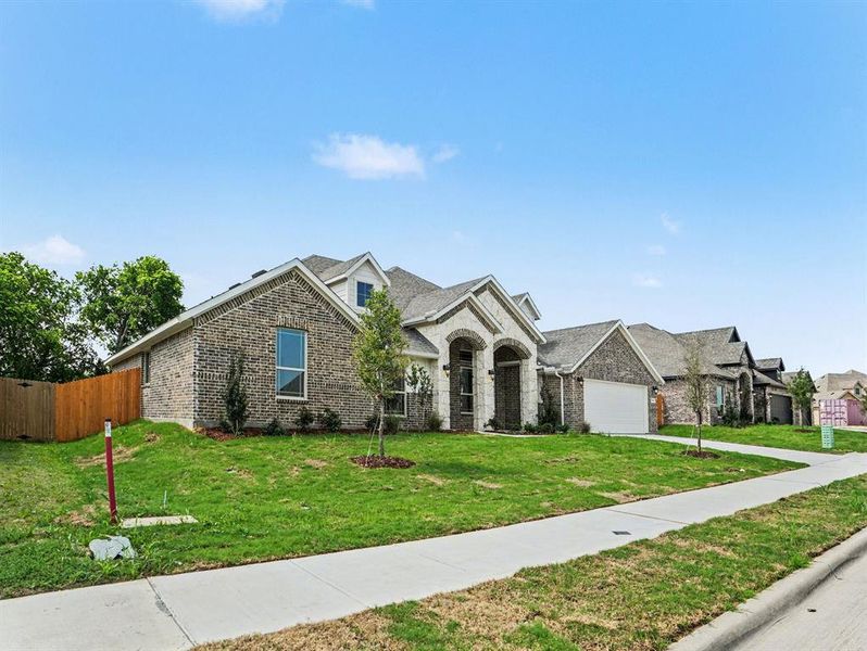 Front exterior of a new home in Cole Crossing Estates, DeSoto, TX, highlighting curb appeal (Image 2). Front exterior of a new home in Cole Crossing Estates, DeSoto, TX, highlighting curb appeal (Image 2).