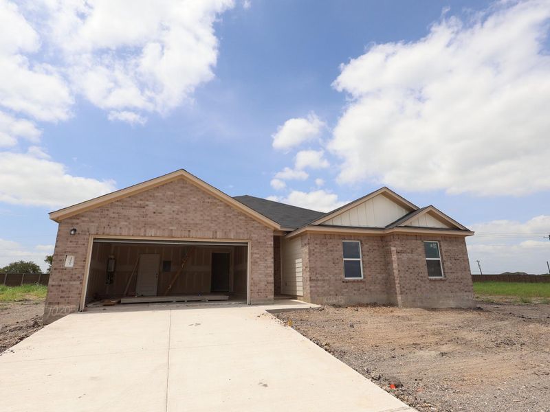 Front exterior of a new home in Willow Springs, Buda, TX, highlighting curb appeal (Image 1). Front exterior of a new home in Willow Springs, Buda, TX, highlighting curb appeal (Image 1).