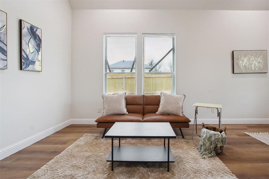 Sitting room with hardwood / wood-style flooring