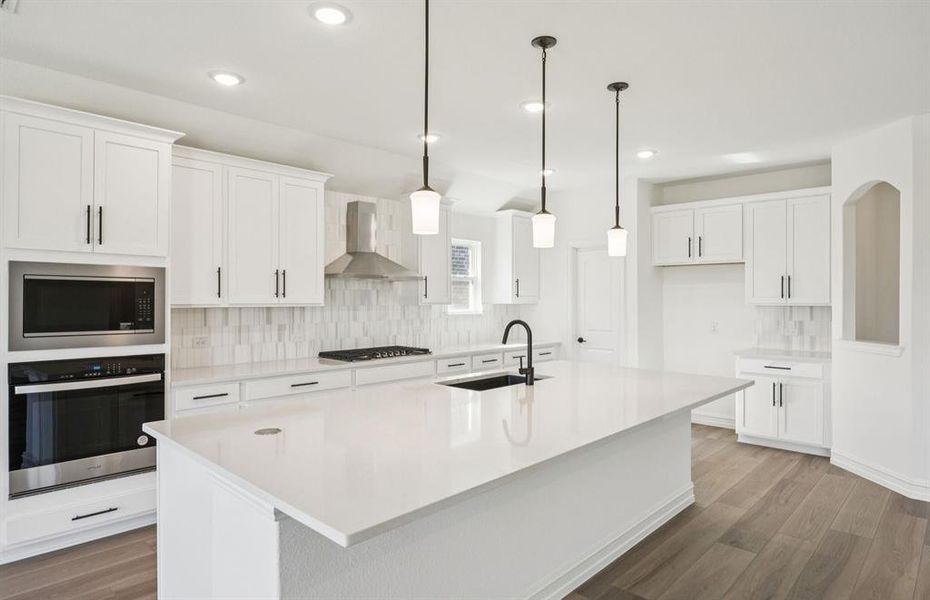 Large island overlooking gathering room and dining areas Large island overlooking gathering room and dining areas