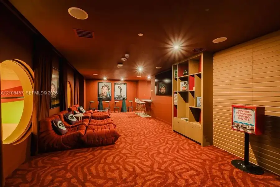 Custom built-in shelving, circular architectural wall cutouts, recessed ceiling lighting, and a built-in counter area Custom built-in shelving, circular architectural wall cutouts, recessed ceiling lighting, and a built-in counter area