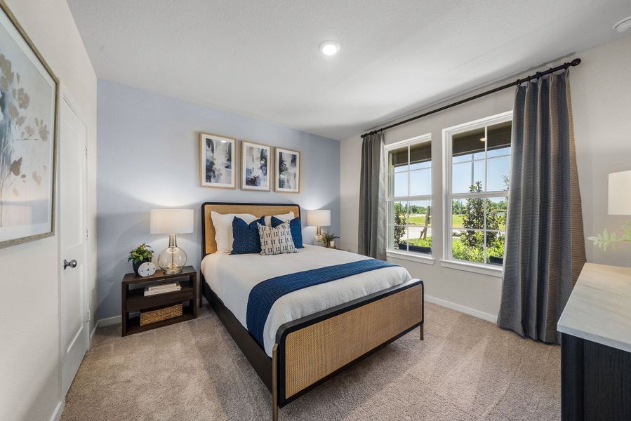 A bedroom with a bed and a window.