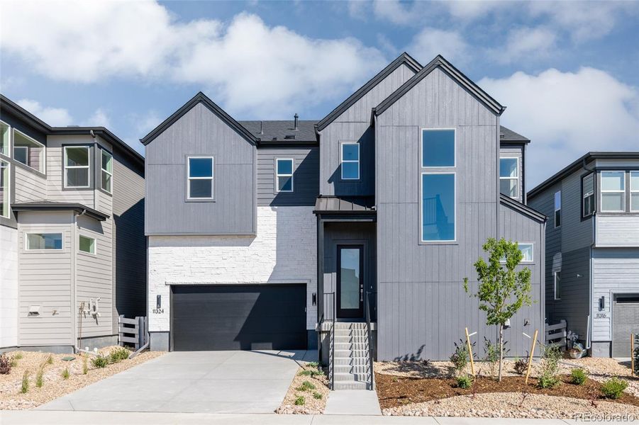 Front exterior of a new home in Lyric at Ridgegate, Lone Tree, CO, highlighting curb appeal (Image 1).