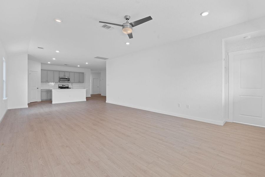 Unfurnished living room with light wood-style flooring, recessed lighting, and ceiling fan Unfurnished living room with light wood-style flooring, recessed lighting, and ceiling fan