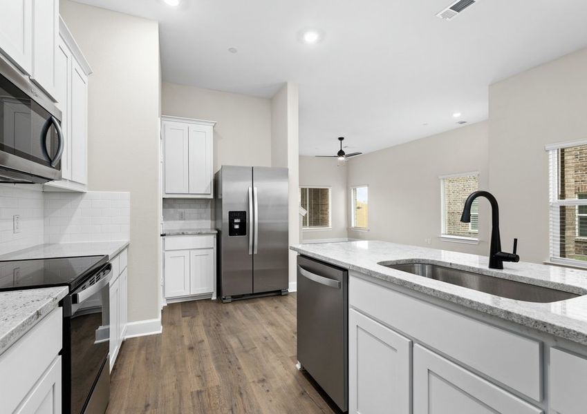 The kitchen has plenty of cabinet space.