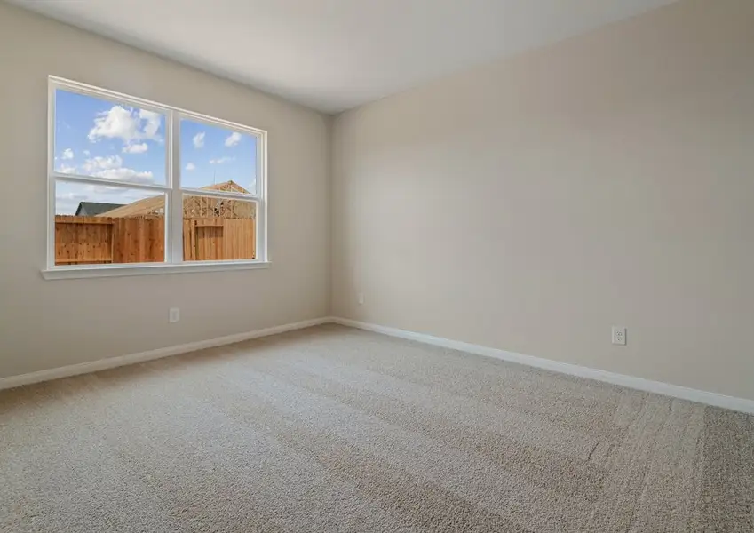 Master bedroom with lush carpet flooring