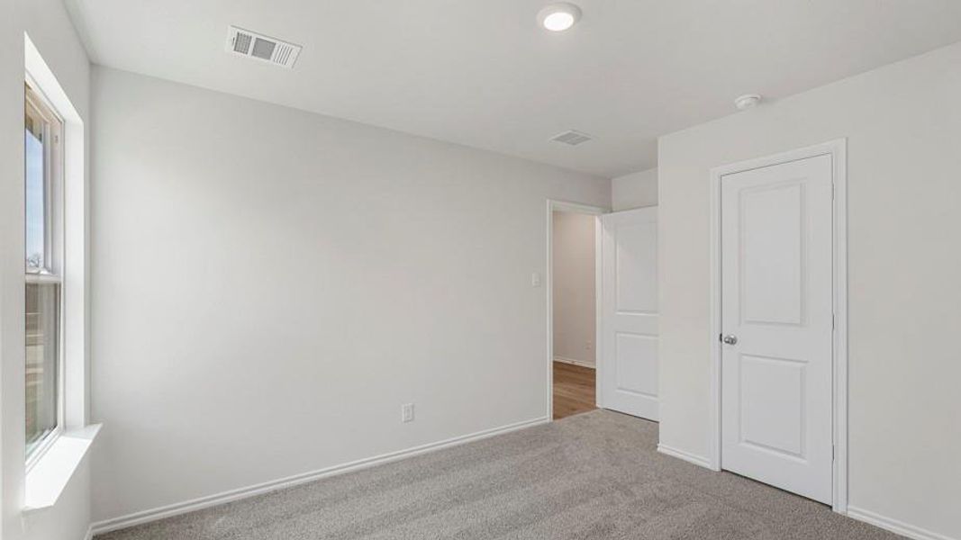 Neutral tone walls with gray carpet flooring