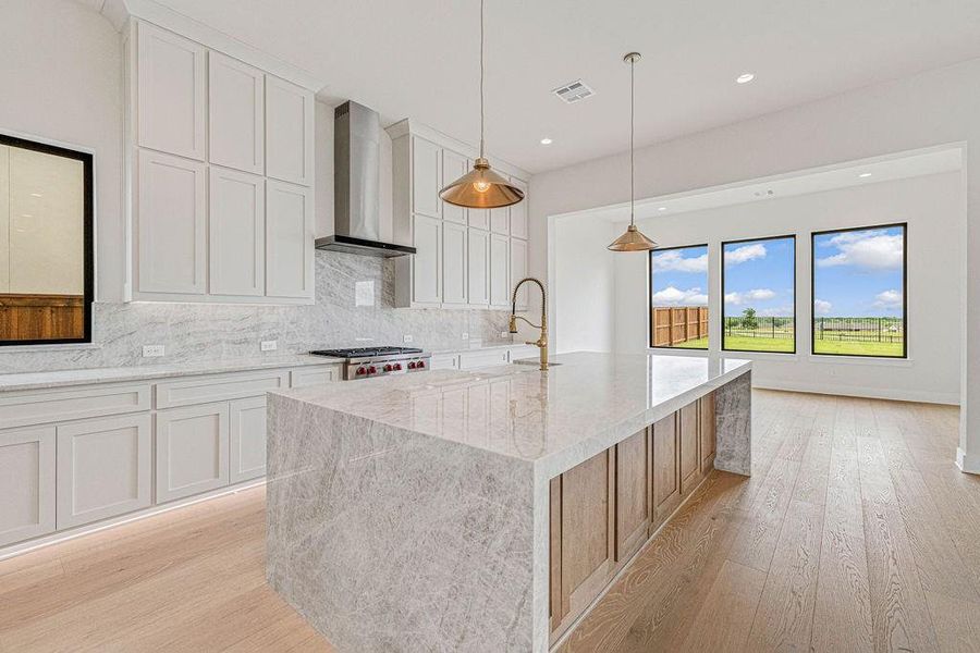 Kitchen cabinets feature under cabinet lighting.