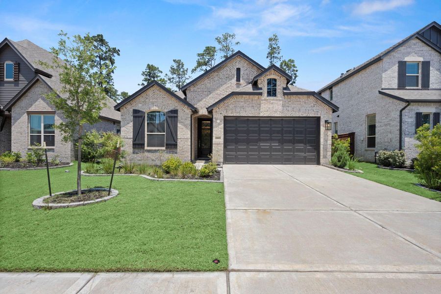 Front exterior of a new home in Evergreen, Conroe, TX, highlighting curb appeal (Image 1). Front exterior of a new home in Evergreen, Conroe, TX, highlighting curb appeal (Image 1).