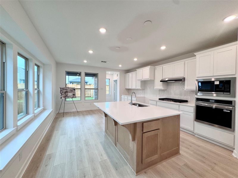Nearly the entire wall is filled with cabinets galore! AND a window bench in the dining room?! You can easily seat 15 people in your kitchen.