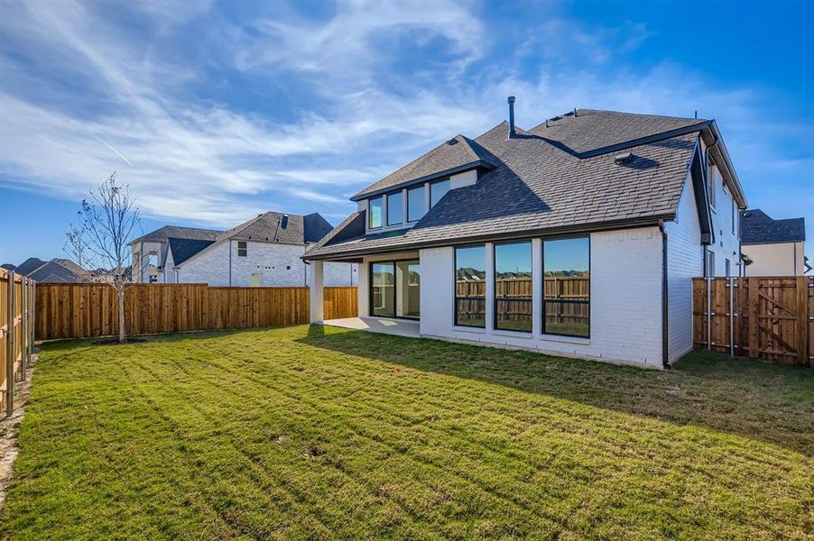 Back of house featuring brick siding, a patio area, a fenced backyard, and roof with shingles Back of house featuring brick siding, a patio area, a fenced backyard, and roof with shingles