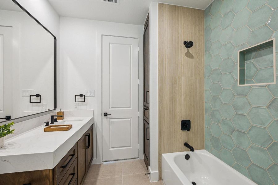 En-suite Bathroom with Sea moss tile and recessed in tub storage. En-suite Bathroom with Sea moss tile and recessed in tub storage.