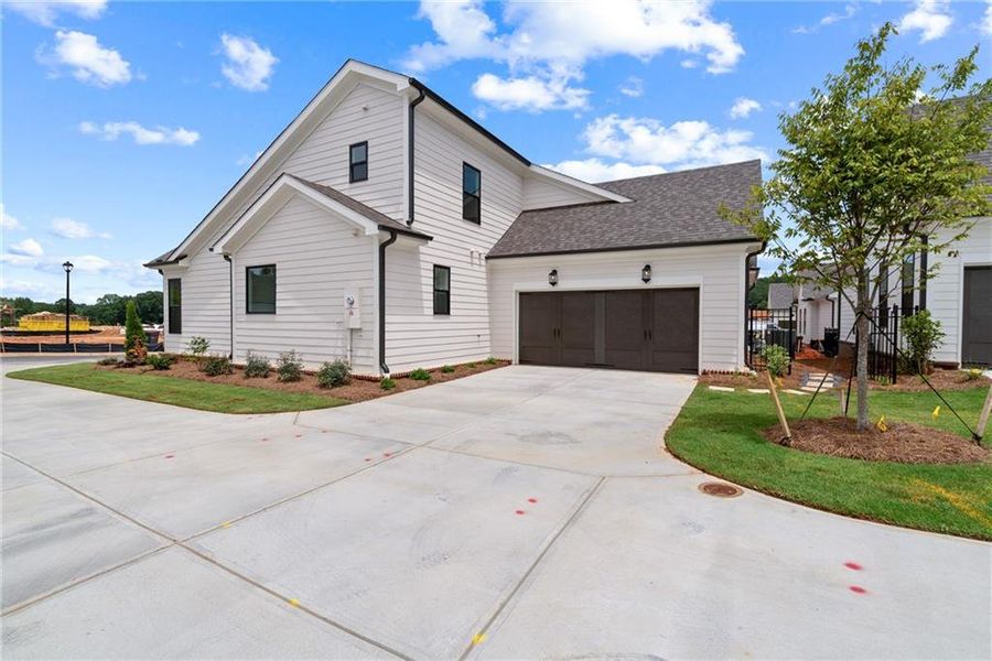 Front exterior of a new home in Promenade at Sawnee Village, Cumming, GA, highlighting curb appeal (Image 19).