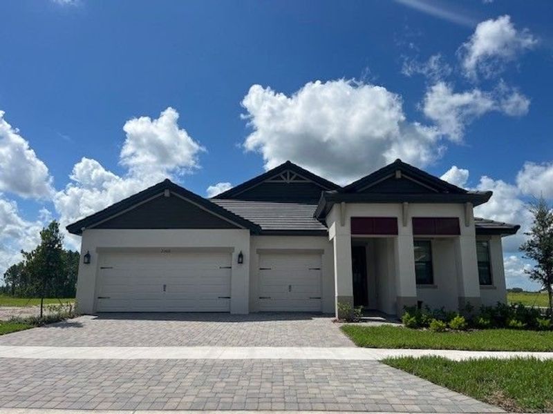 Representative exterior photo of a completed home built from the 60' - Charlotte by William Ryan Homes in Pinecone Reserve, Brooksville, FL (Image 21). Representative exterior photo of a completed home built from the 60' - Charlotte by William Ryan Homes in Pinecone Reserve, Brooksville, FL (Image 21).