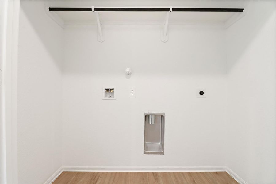 Spacious utility room is conveniently located in hallway Spacious utility room is conveniently located in hallway