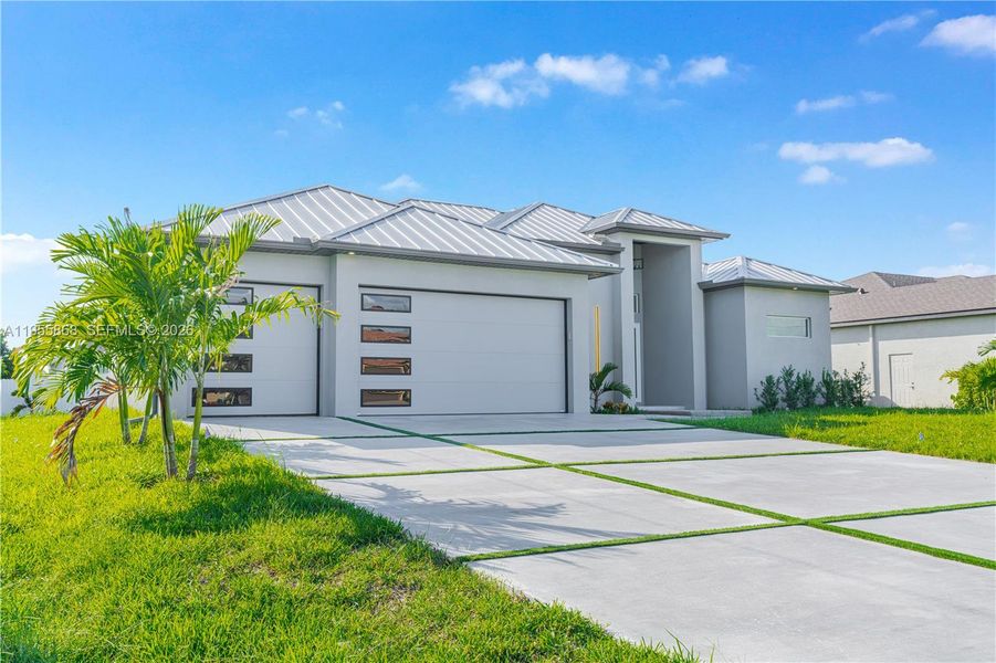 Front exterior of a new home in , Cape Coral, FL, highlighting curb appeal (Image 1). Front exterior of a new home in , Cape Coral, FL, highlighting curb appeal (Image 1).