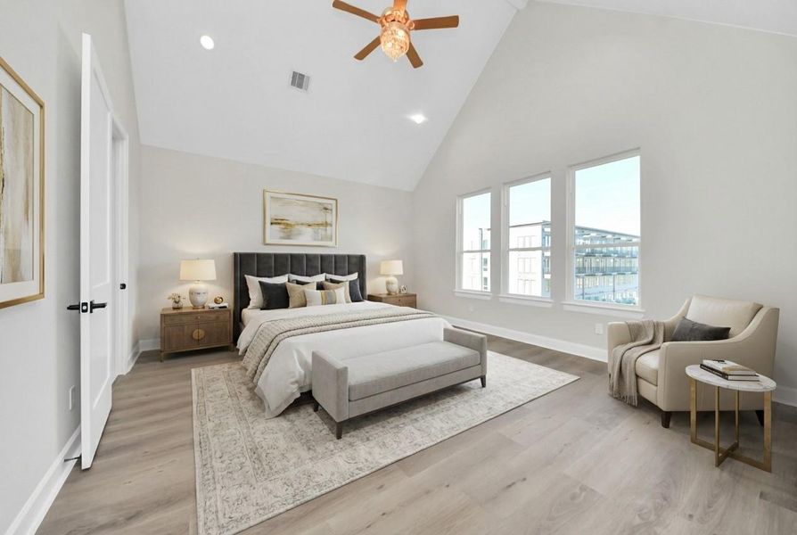 Luxurious primary suite featuring abundant natural light and a serene ambiance.