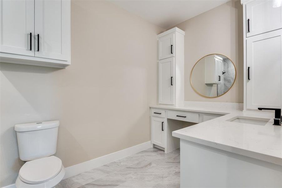 2 of 3 full bathrooms with double vanities, and double linen closet as well as make up area 2 of 3 full bathrooms with double vanities, and double linen closet as well as make up area