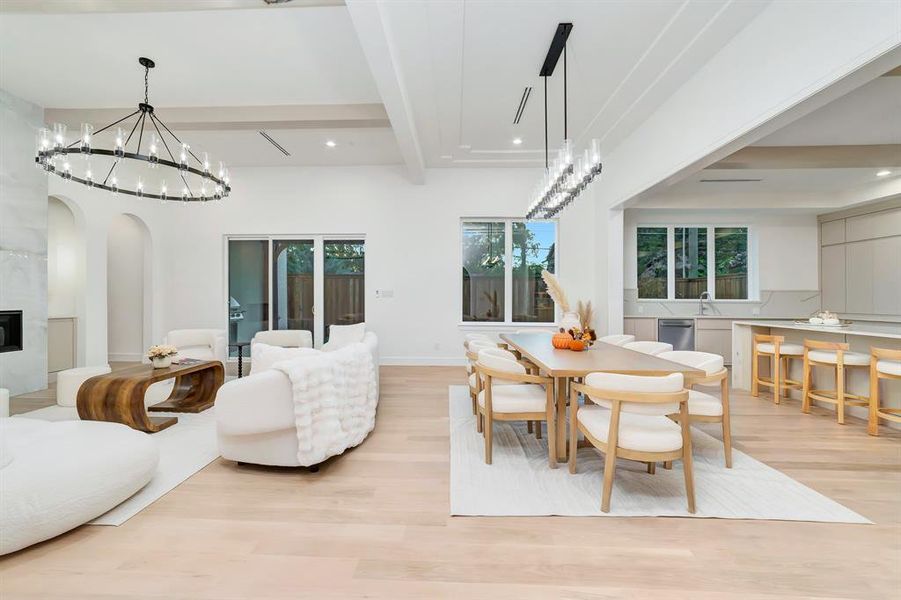 Dining area with beamed ceiling, a chandelier, light wood-style floors, and recessed lighting Dining area with beamed ceiling, a chandelier, light wood-style floors, and recessed lighting