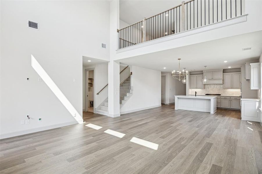 The family room is open to the game room upstairs creating multiple levels of open concept space for entertaining!