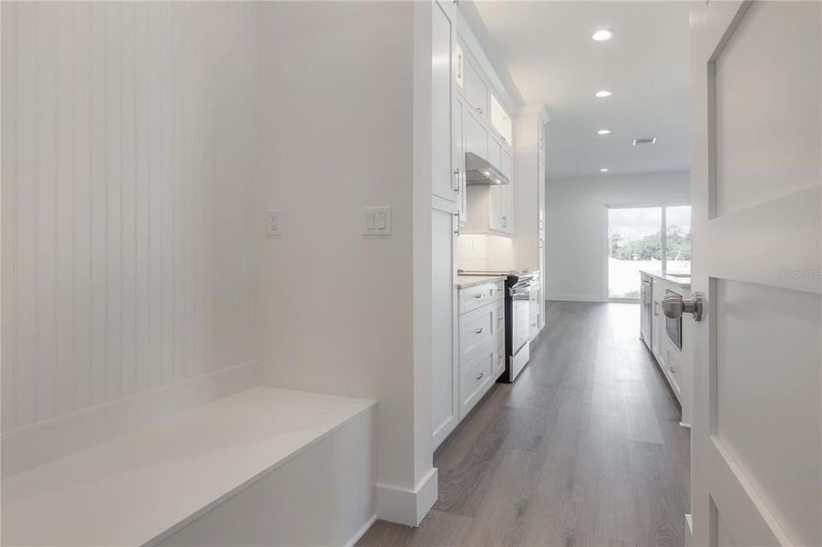 Garage entry foyer. Specific finish colors may be differ. Photo is from another completed unit.