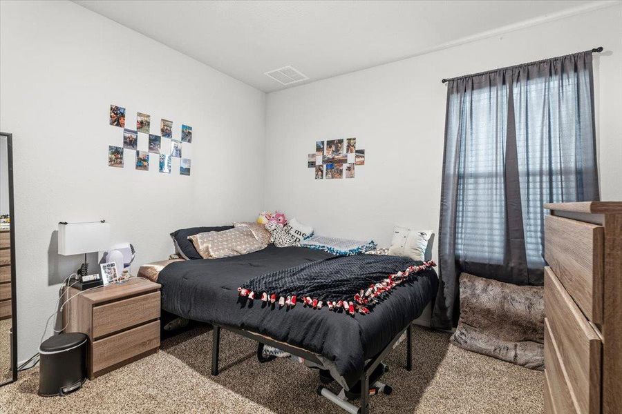 Bedroom featuring light colored carpet