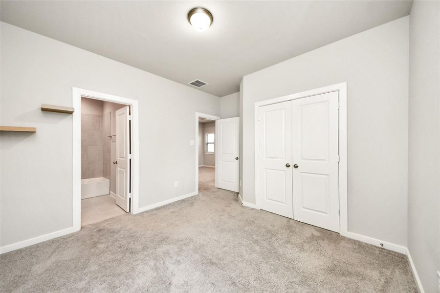 Alternate view of a secondary bedroom showcasing its generous layout, neutral palette, and move-in-ready condition.