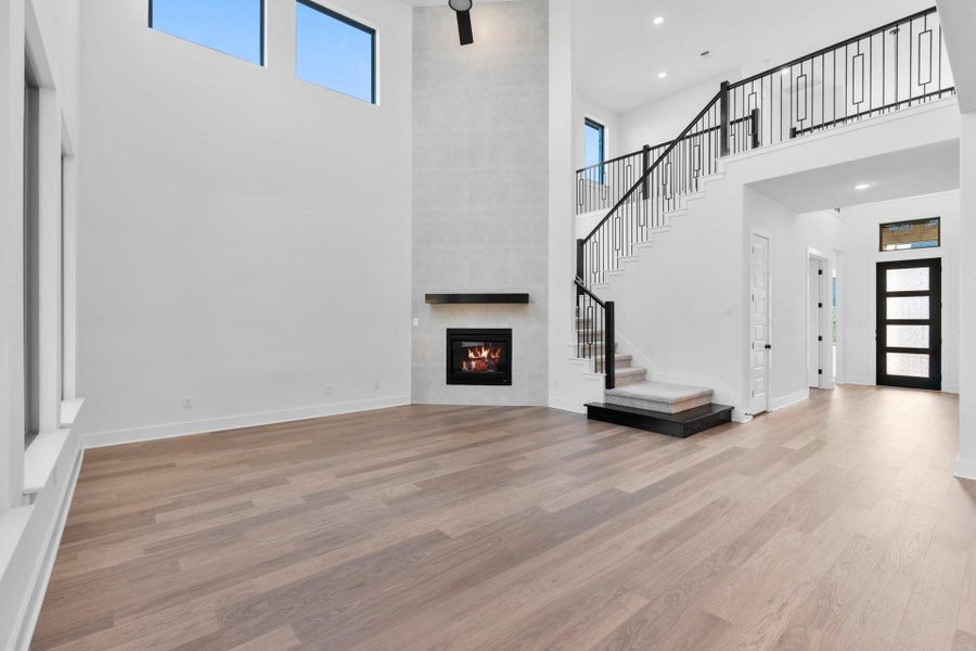 Family Room with soaring ceiling & fireplace