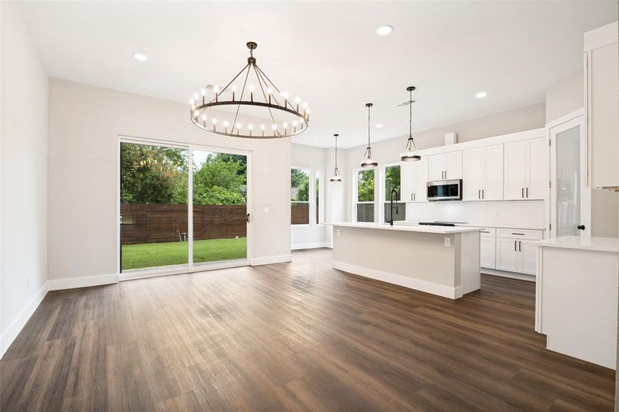 Open-concept living area with wood-finish flooring