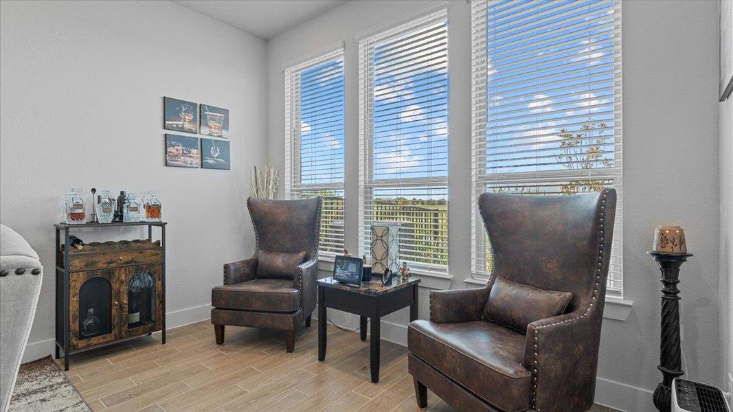 Sitting room featuring wood finish floors and baseboards Sitting room featuring wood finish floors and baseboards