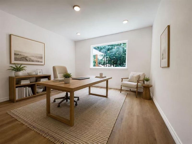 Bright room with wood-finish flooring, recessed lighting, and a large window Bright room with wood-finish flooring, recessed lighting, and a large window