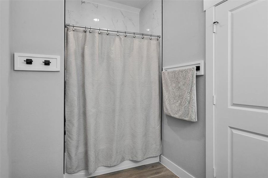 Upstairs bath has shower/tub combo, quartz counter and storage.