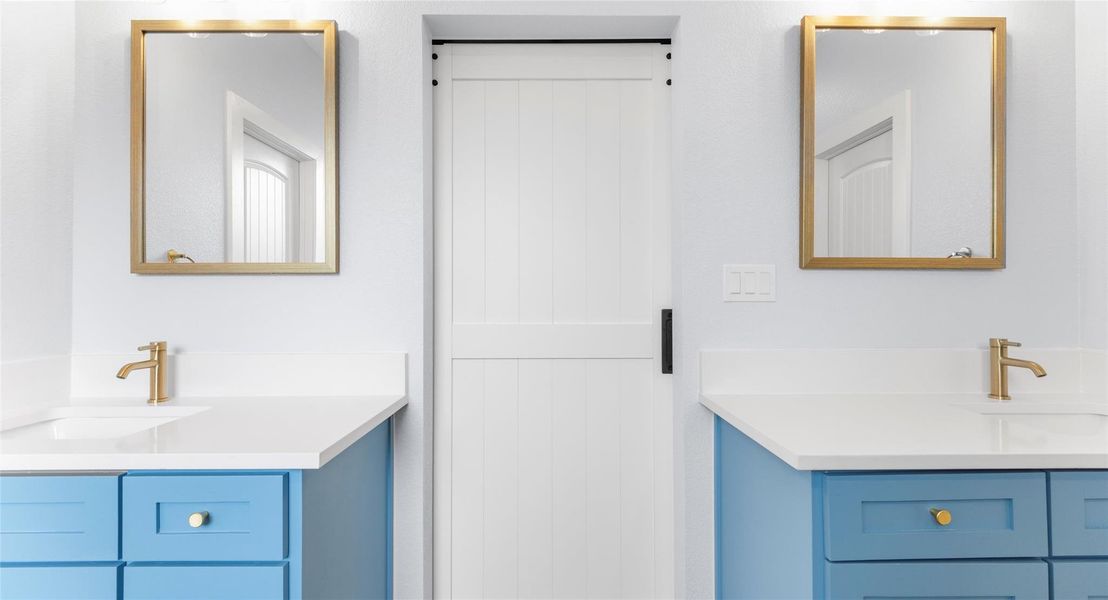 Full bath featuring two vanities