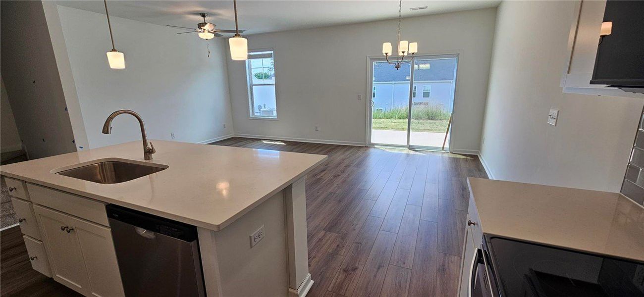 This bright kitchen with a breakfast bar seamlessl This bright kitchen with a breakfast bar seamlessl
