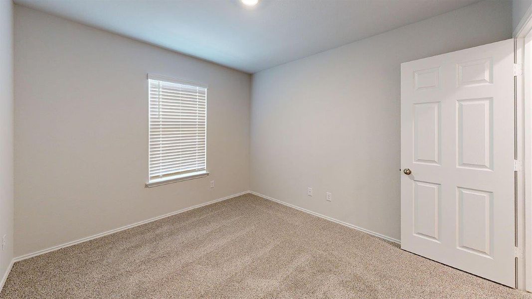 Neutral-toned wall paint and textured carpeting define this room