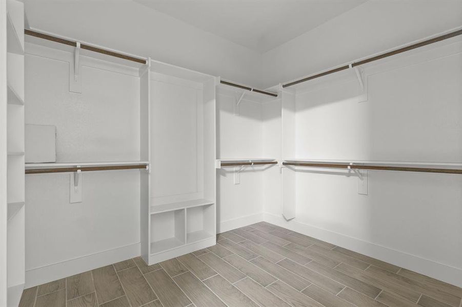 Spacious closet with wood finish floors