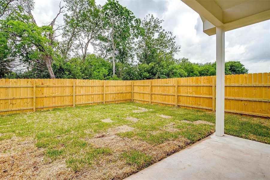 View of yard featuring a fenced backyard and a patio area View of yard featuring a fenced backyard and a patio area