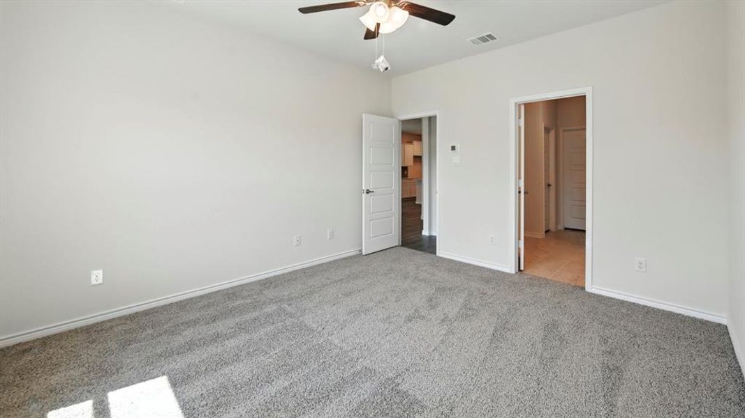 Unfurnished bedroom featuring carpet floors and a ceiling fan Unfurnished bedroom featuring carpet floors and a ceiling fan