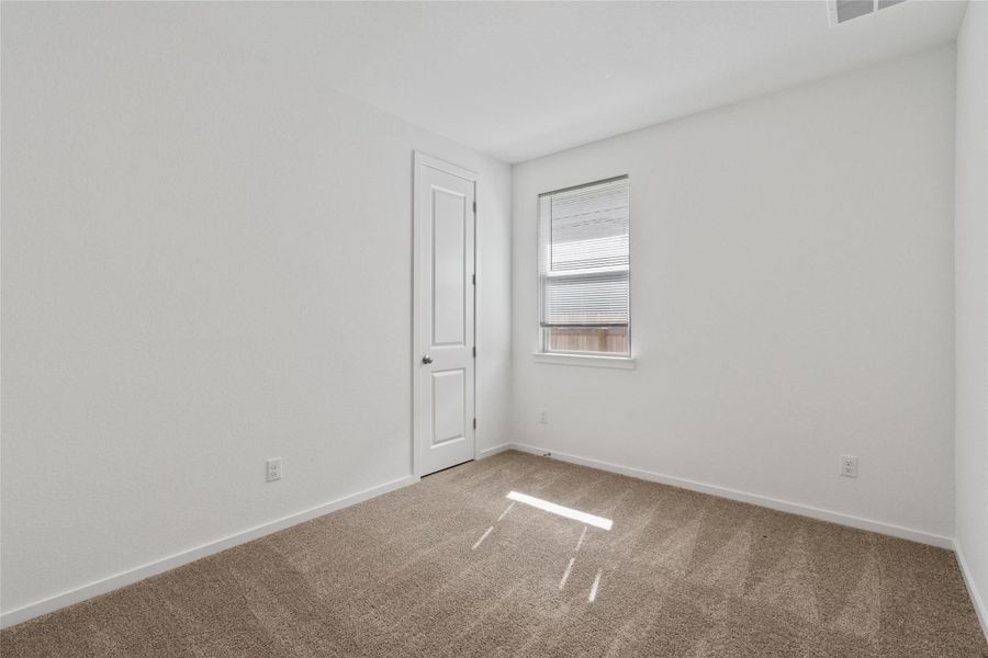 A well-lit bedroom offering a blank canvas for personalization.